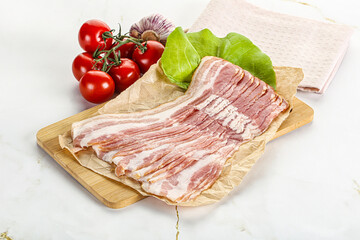 Sliced pork bacon oved board