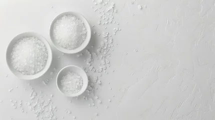 Fotobehang Simple yet elegant kitchen staples: three bowls of salt on a white background. ideal for culinary concepts and minimal design. photographed with natural light. AI © Irina Ukrainets