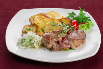Meat steak with side dish on a white plate, restaurant menu