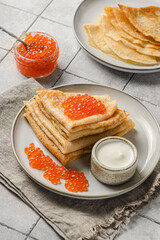crepes with red caviar and sour cream