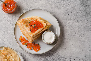 crepes with red caviar and sour cream