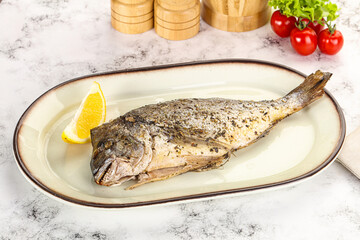 Baked Dorado fish served lemon