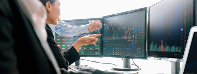 Group of skilled investor discuss about stock investment. Businesspeople look at stock charts before making investment decisions. Stock market trading concept. Cropped image. Closeup. Burgeoning. - obrazy, fototapety, plakaty