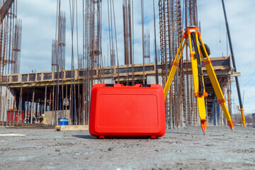 plastic protection case for 3D laser scanner  and surveyors tripod on construction site in sunny...
