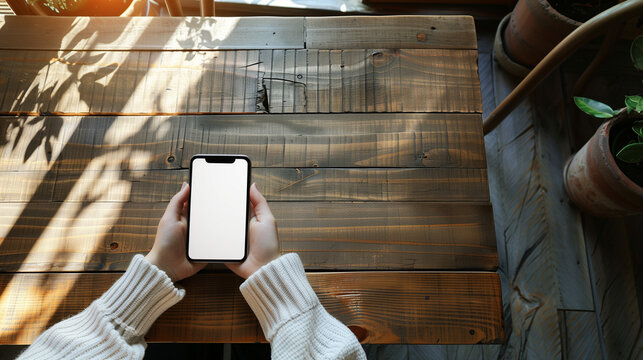 Hand holding smart phone with blank screen on traditional wooden table, Ai generated Images