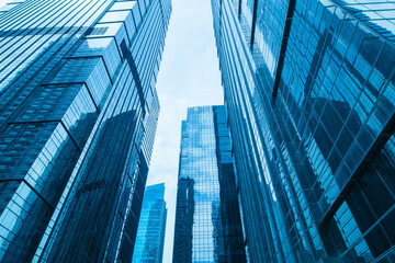 Office tall building. Low angle view of skyscrapers office building in central business district with blue sky