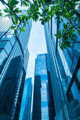 Office tall building. Low angle view of skyscrapers office building in central business district with blue sky