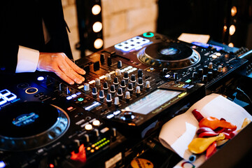 Dj at work party colors playing music wedding disco console enterteinment mixer buttons dancing...