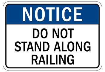 Railroad safety sign do not stand along railing