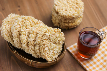 Indonesian traditional crackers Rengginang made from glutinous rice served in bamboo bowl on the table