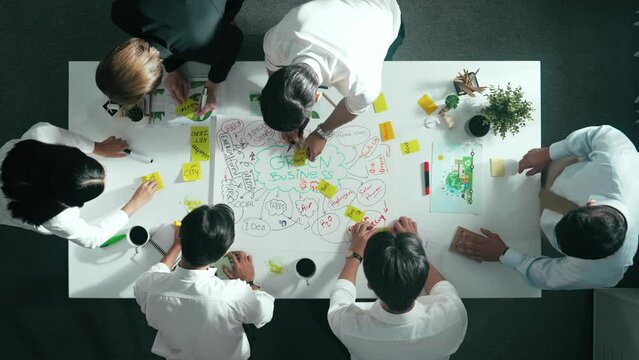Top view of professional business team working together to brainstorm environmental idea by using mind map. Aerial view of smart manager talking and discussing about sustainable energy. Alimentation.