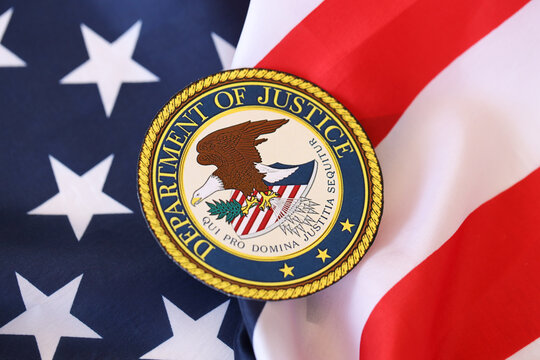 KYIV, UKRAINE - MARCH 9, 2024 US Department of Justice seal on United States of America flag close up