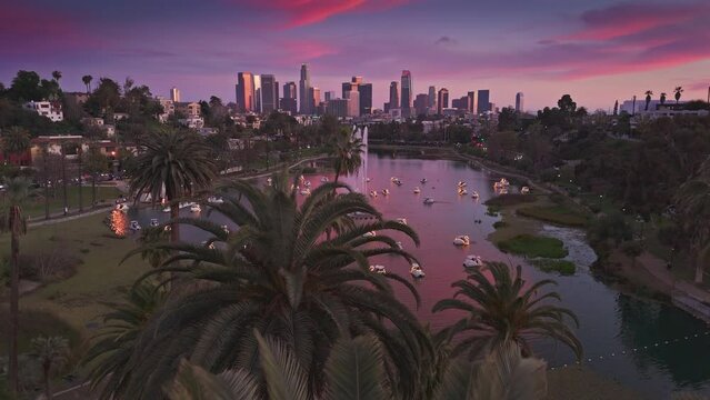 Aerial view of Echo Park Lake and downtown Los Angeles skyline at sunset. 4K UHD.