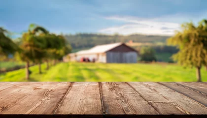 Selbstklebende Fototapeten The empty wooden brown table top with blur background of farm and barn. Exuberant image. for text to present products © Uuganbayar