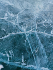Abstract natural ice texture. Freezy ice surface. Blue backdrop with cracks and scratches on frozen...