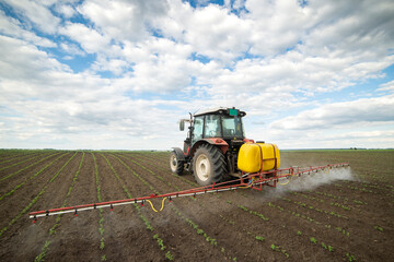 Obraz premium Spraying pesticides at soy bean fields