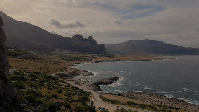 drone flying through a cave, San Vito Lo Capo Sicily, San Vito lo Capo Beach, and Monte Monaco in the background, north-western Sicily. cliffs and rocky coastline in Sicily