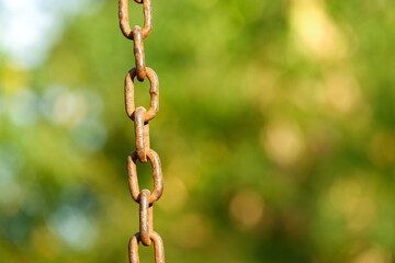close up of chain with blur green bokeh background