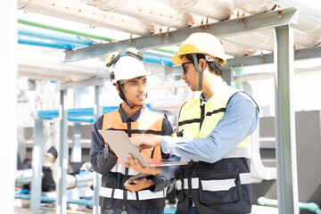 Obraz premium Group of male plumber engineer working at water pipes system at building. Team of Asian male plumber working at water pipes network system of building