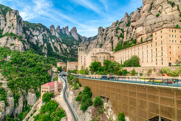 Santa Maria de Montserrat abbey in Monistrol, in a beautiful summer day, Catalonia, Spain - obrazy, fototapety, plakaty