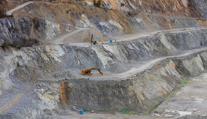 Sandstone quarry with excavator equipment. Digging industry background, Czech landscape