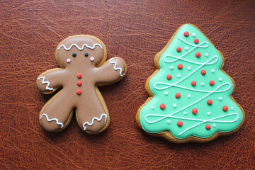 Shortbread Cookies In Shape Of Funny Man And Pine Tree On Brown Leather Surface Concept Design For Greeting Card 