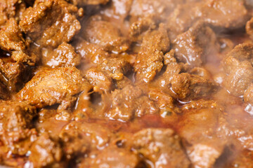 Close-up of beef rendang in the making, a popular traditional indonesian dish. Selective focus