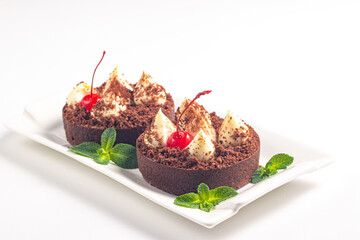 Delicious chocolate tart garnish with cherry and mint. Classic dessert. - 760444660