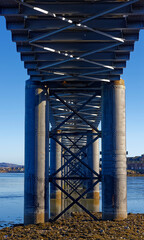 Looking through the Cross braced Cylindrical Piers filled with concrete of the South Esk Rail Bridge at the coastal town of Montrose.