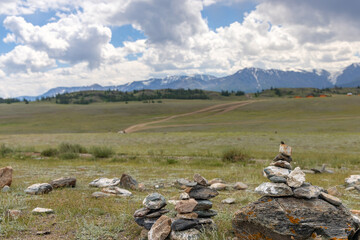 stones heap in front of high mountains - 760447078