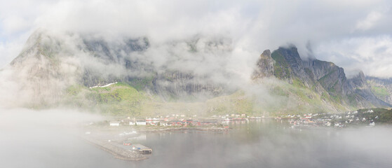 The village of Reine in Lofoten Islands on a beautiful foggy summer morning, Norway