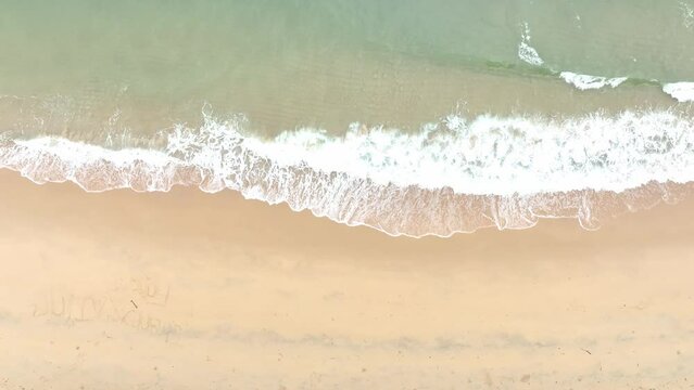 The soft wave water of the sea on the sandy beach background	