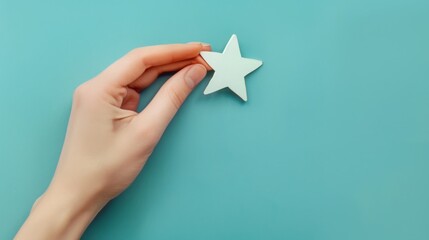 Woman's hand holds one star on a blue background, copy space, 16:9
