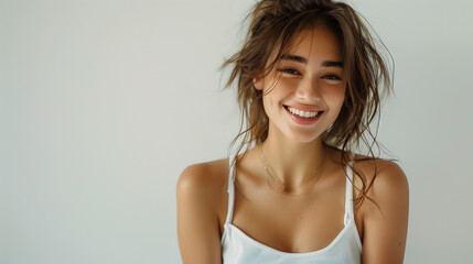 Beautiful young sexy caucasian woman with a fashion hairstyle and subtle smile, wearing a white sleeveless top, exuding a sophisticated charm.