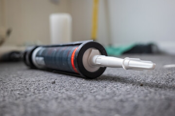 Used sealant cartridge gun on carpet floor in england uk