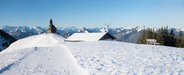 Wallberg mountain plateau with chapel and hut, snowy winter landscape