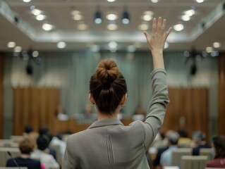 woman at a presentation raising her hand. 