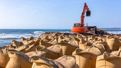 Beach Ocean Excavator Machine Sand Bag Barrier Wall Construction Weather Environment - 760486638