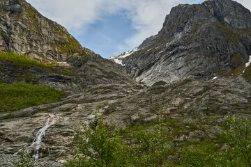 Blue Bondhusbreen Glacier hanging in the mountains over the Bondhusvatnet Lake and in Sundal, Vestland, Norway