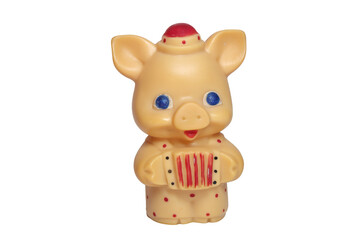 funny piglet with big blue eyes toy, in little hat and colored polka dots jumpsuit playing at concertina. on white background