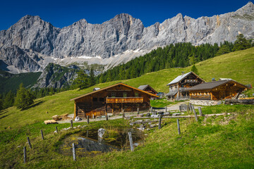 Wooden houses on the slope in the Alps, Austria - 760489453