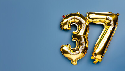 Banner with number 37 golden balloon with copy space. thirty seven years anniversary celebration concept on a blue background.