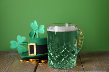 St. Patrick's day party. Green beer, leprechaun hat, gold and decorative clover leaves on wooden...