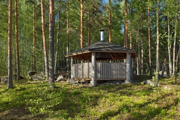 Wooden tourist shelter with fire place in forest on the island of Kalainsaari, Päijänne National...
