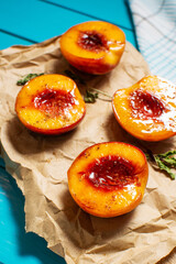 Baked peaches with honey and cinnamon on blue wooden background. summer dessert.