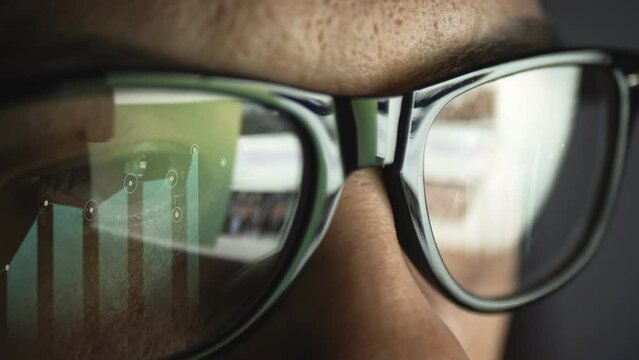 Cg footage with reflection in glasses of searching for information on the Internet and a growing chart with maximum and minimum values.