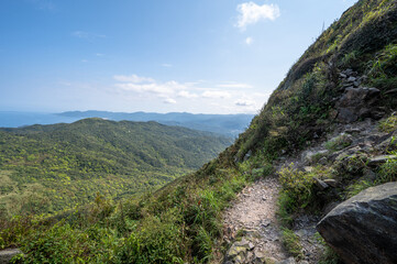 Fototapeta na wymiar Shooting from half way of mountain trail, green mountain and blue ocean into the eyes, in Jiufen, Jinguashi, New Taipei City, Taiwan.