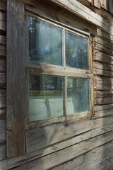 Closeup of old weathered and worn wooden planks with framed window.