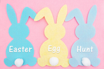 Easter Egg Hunt sign with a bunny and on weathered wood