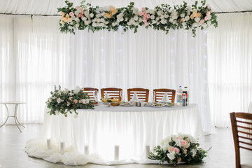 Fototapeta na wymiar Elegant wedding reception venue, beautifully decorated with drapes and floral arrangements. Ideal for wedding planning content, venue marketing